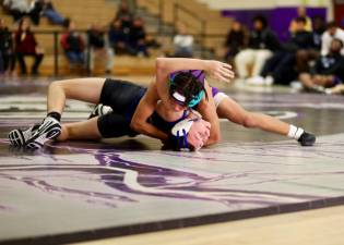 Crusader Elijah Brown (top) won a tech-fall 17-1 at 131 lbs.