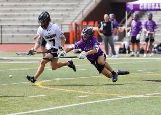 Monroe-Woodbury’s Gavin Fitzgibbon dives for the ball after a face off during the Boys Lacrosse state quarter finals on June 7.