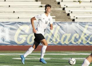 Ibrahim Cela, #14, looks to move the ball out of the defensive end.