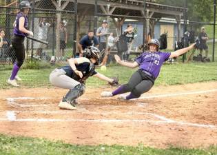 Cori Exarchakis, #23, slides safely into home in the fourth inning.