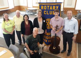Alex Prizgintas (with cello) stands with members of the Monroe-Woodbury Rotary.