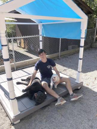 Joe Melillo at the Woodbury Animal Shelter sitting in his completed project.