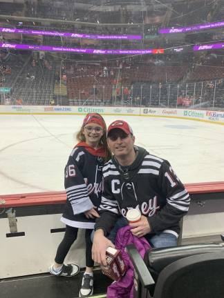 Lexie Myrhen, 7, with her dad, Jeff, at a Devils game. (Provided photo)