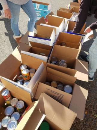 Girls helped load up boxes with a range of food items for those with food insecurity issues to ensure they have a proper Thanksgiving meal.