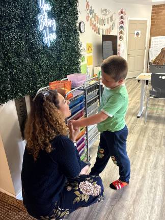 Roots &amp; Wings Founder Jenny Mills talks to student Roman Yangis-Faulkner, of Greenwood Lake, NY, the second day of school.