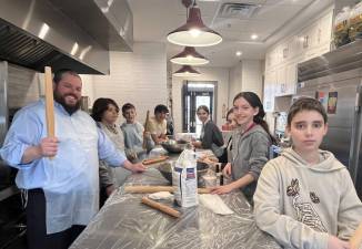 Rabbi Pesach teaches his class at Chabad Hebrew School how to make Passover Matzah.