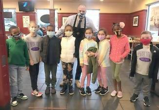 Pictured from left to right are members of the Pine Tree Elementary community: Kaliek Johnson, Lilly Sefer, Mason Bell, Kai Bell, Assistant Principal Timothy Martin, Ava Farahvashi, Emma Farahvashi, Nissi Ogunyemi and Logan Kaiser.