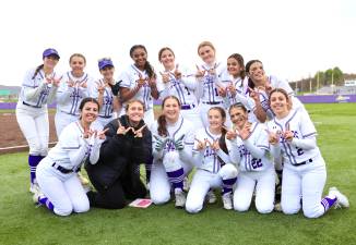 The Crusaders Varsity Softball celebrates their opening day victory over the Middies.