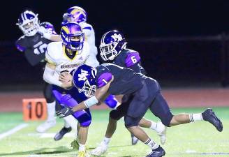 Let the footbal season begin: Christopher Graham (#1) makes the tackle on the opening kick off. Photos by William Dimmit.