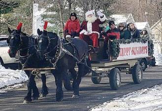 After arriving at Smith's Clove Park via helicopter, Santa and Mrs. Claus were taken to the historic Rest Haven house in the Village of Monroe for holiday festivities.