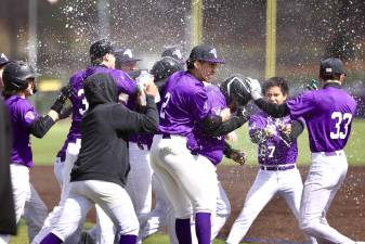 The Crusaders baseball team celebrates their season-opening win over Beacon.