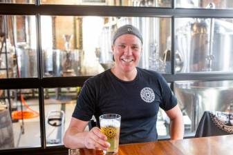 Clemson Bros. Brewery owner Kenan Porter sipping on a fresh poured Clemson Pilsner