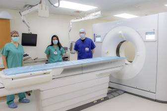 Technicians at St. Anthony Community Hospital and the hospital’s new 256 Slice CT scanner, which can capture a complete image of the heart or brain quickly, reducing radiation exposure and helping to protect the imaged tissue and surrounding areas. Provided photo.