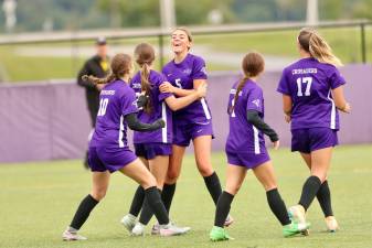 Kylie Baisley #5 celebrates with team after a Crusader goal.