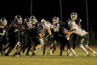 The Crusaders defense swarms to stop the Warriors’ Gallo in the second half.