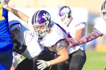 Offensive tackle Ty Kohrs (54) blocks on the Crusaders’ point-after-attempt in the second quarter against Washingtonville. Photos by William Dimmit.