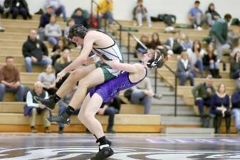 Crusader Danny Downs hoists his Dragon opponent into the air on his way to a 13-3 decision.