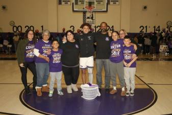 Senior, Samuel Fileen poses with his family before the game