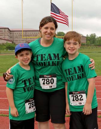 Lorraine Voelke Griffenkranz, Paul's wife, and their two sons Ben and Andrew before the race on Sunday.