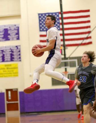 High-flying Rob Vacco (#4) led the Crusaders with nine points on the night.