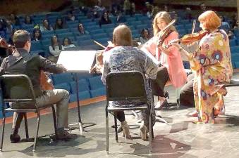 Music teachers Hana Walton, Michele George, Lauren Buono, and Peter Giorgo play Sorenson’s “Shine You More” at the recent M-W Faculty and Friends Concert.