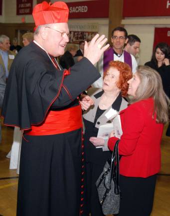 Photo by Ed Bailey Cardinal Timothy Dolan, the archbishop of New York, shares a few words with participants following an evening of prayers for the Archdiocesan Stewardship Appeal held last Thursday at Sacred Heart Parish in Monroe. The church&iacute;s pastor, the Rev. Thomas J. Byrnes, center, looks on.