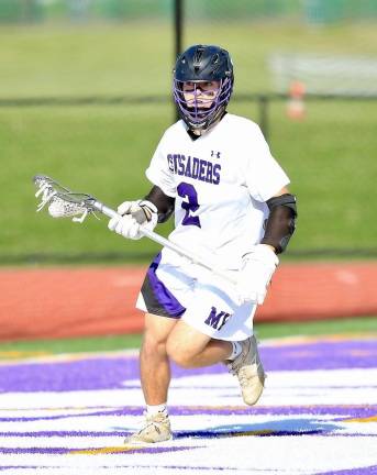 Senior Colin Duffy swings around the Wizard goal in the second half.