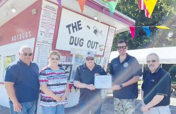 Assemblyman Colin J. Schmitt presents the Small Business of the Month Award to The Dug Out owner Earl Cronk, alongside Trustee Jesus Gomez (left), Laurel Wentick (sister of the owner) and Trustee Andrew Giacomazza (right). Provided photo.