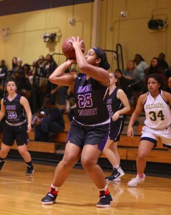 Photo by William Dimmit Savanah Paul (#25) lines up a jump shot in the first quarter.