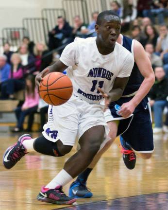 Monroe-Woodbury guard Isaiah Collins-Brown drives against a Suffern defender.