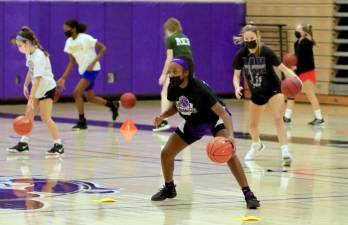 Layla Green leads the Monroe-Woodbury Varsity Girls Basketball team through drills last week while she adn her teammates maintain their distance. Photo by William Dimmit.