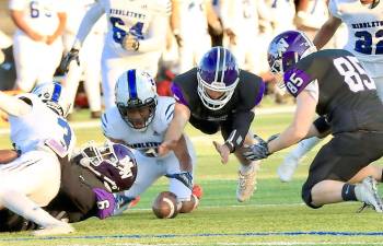 The Crusaders pounce on the Middie fumble in the opening quarter. Photos by William Dimmit.