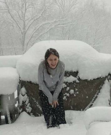 Monroe resident Laura Walker attempts to coax her dog Ginger outside and onto the deck during the March 7 storm dubbed Quinn by The Weather Channel, but Ginger wisely opted to stay indoors.