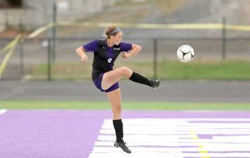 Gabrielle Mpasiakos (#8) pops the ball over the Warwick goalie to score the first Crusader goal.