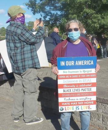 Iris Conques said she pulled her sign up from her lawn and came to the rally to walk.