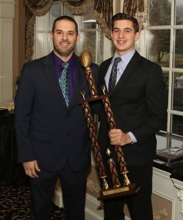 Photos by William DimmitMonroe-Woodbury Head Football Coach Ryan Baldock gives Steven Campione his MVP Award.