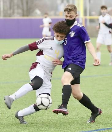 Justin Ely #3, collides with a Tiger defender while battling for possession