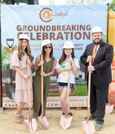 Digging into the future: Chabad Hebrew School student Ruby Eberly of Monroe, pictured with her mom, Robin, and Rabbi Pesach and Chana at the Chabad Campus Groundbreaking Celebration.