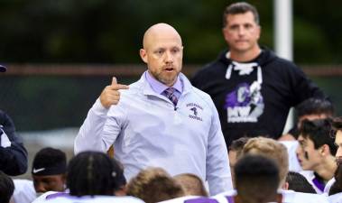 Crusader Head Coach James Sciarra address the team just before start of the game.