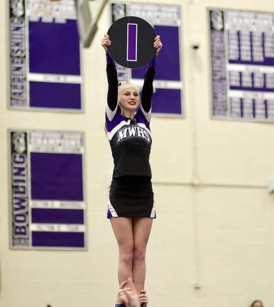 Audrey Whitfield holds her letter high as she is lifted in the air by her teammates.