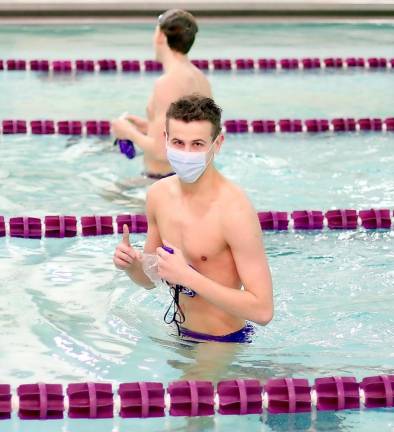 The new look of swimming: Shane Douthit celebrates his victory in the 100 Free Style while following safety protocols.