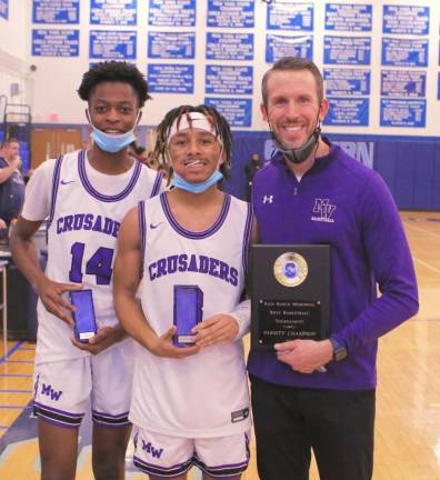 Crusaders Jeremiah Arne (#14) and Cameron Spears (#3) hold their All-Tournament Awards as Head Coach James Hahn holds the Rich Bosco Memorial Tournament Trophy. Photos by William Dimmit.