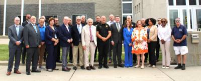 Local legislators, law enforcement leaders and others gather at the Orange County Sheriff’s Office to announce the extension of death gamble benefits.