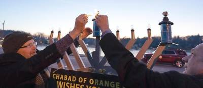 Monroe Village Mayor Neil Dwyer and Monroe Town Supervisor Tony Cardone light the “shamash” candle at the Monroe Menorah Lighting. “Shamash means the ‘servant candle,’ the one that lights the other candles,” explained Rabbi Pesach. “In the ‘human menorah’ the elected officials serve as the ‘shamash’ of the community. So, the ‘shamash’ lights the ‘shamash!’”