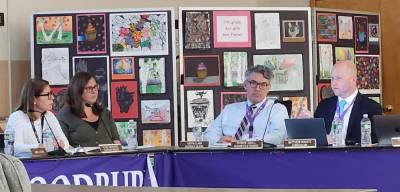 Superintendent Elsie Rodriguez. far left, asks Matthew Kravatz, Assistant Superintendent for Curriculum and Instruction (UPK - Grade 5), for an update on the district’s goals. Photo by MJ Hanley-Goff.