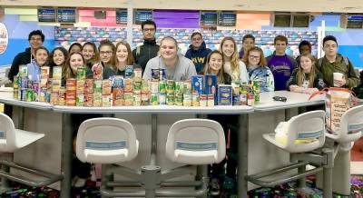 The Monroe-Woodbury girls and boys varsity bowling teams ran a non-perishable food drive to benefit Our Father's Kitchen at Sacred Heart Church in Monroe. The young athletes are pictured here at the Colonial Lanes in Chester with the 72 items they delivered to the food pantry.