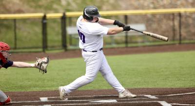 Crusader first baseman Josh Konior launches a double in the Crusaders’ sixth inning rally. Photos by William Dimmit.