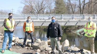 Orange County DPW Director of Project Management Ryan McGuire, Deputy DPW Commissioner Travis Ewald, Orange County Executive Steven M. Neuhaus and DPW Commissioner Erik Denega at the Grove Drive Bridge in Tuxedo on Tuesday, April 28.