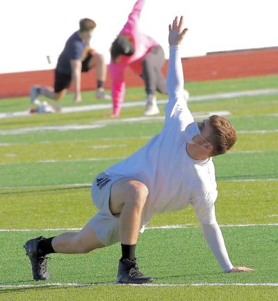 Streching out, the Crusaders take advantage of the warm November weather to prepare for spring.