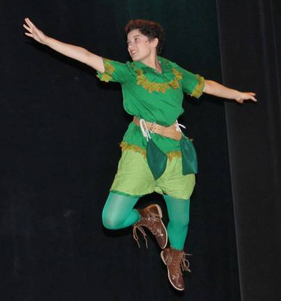 Photo by Bob Curtis Peter Pan (Anya Quinn) demonstrates some of his best flying techniques for the Darling children prior to leading them to Neverland during a recent dress rehearsal for Souza&#x2019;s Peter Pan, opening this weekend.